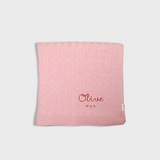 Pink merino baby blanket with rosette cross stitch embroidery and personalized name Olive