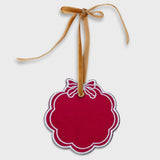 Red scalloped pet ornament with white embroidered bow and gold velvet hanging ribbon