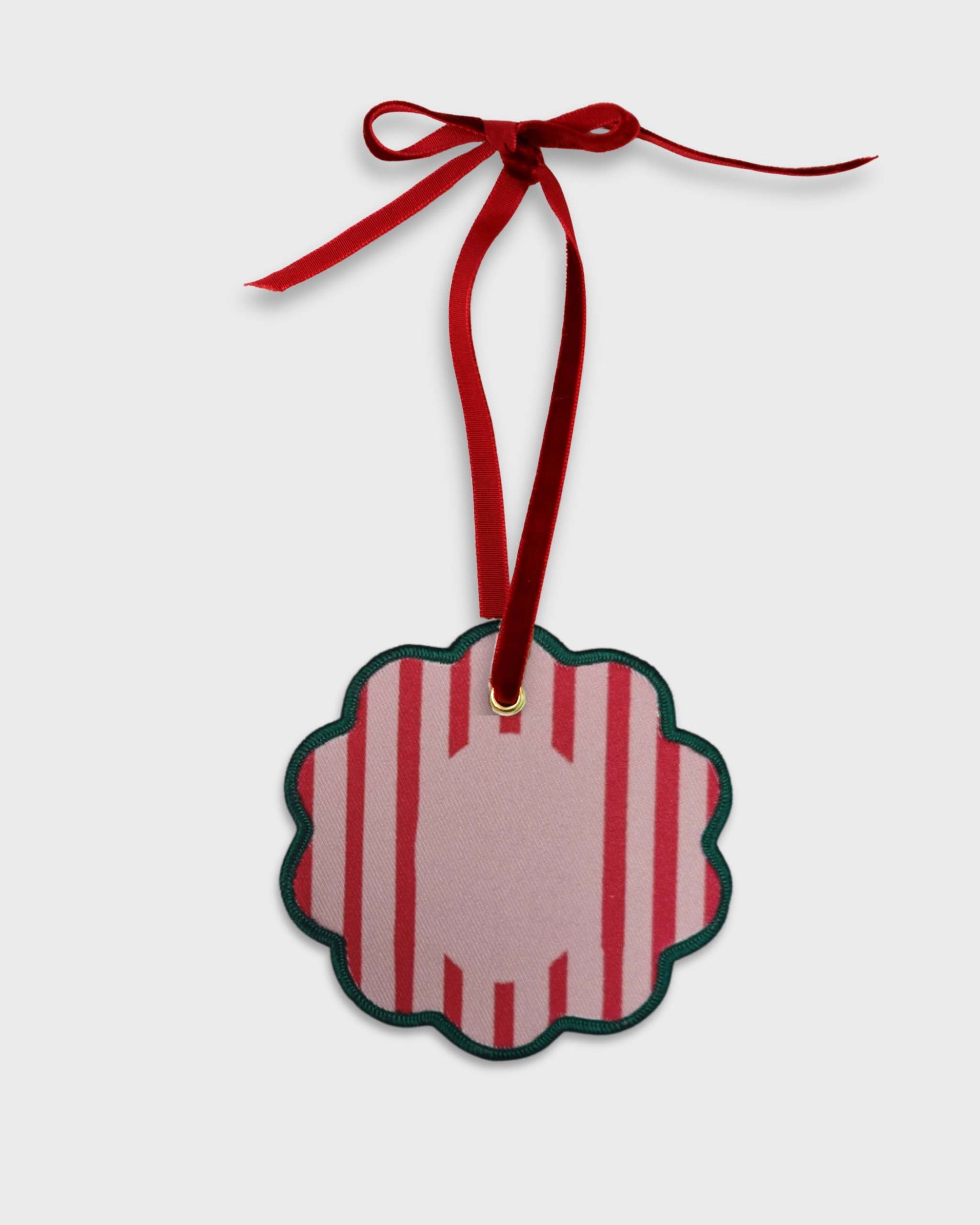Personalised pet ornament with red and pink stripes, velvet ribbon, and scalloped edge for holiday decorating