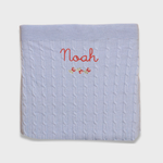 Merino baby blanket with rosette design and personalized embroidery.