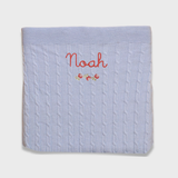 Merino baby blanket with rosette design and personalized embroidery.