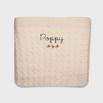 Merino baby blanket with rosette embroidery, personalized design.