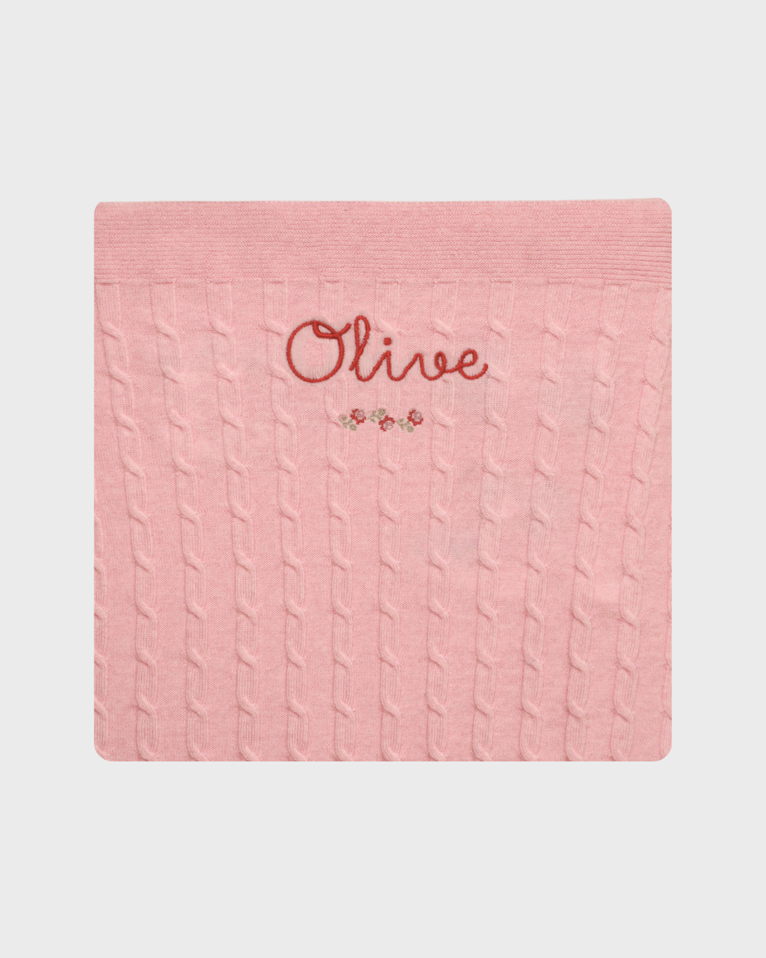 Merino baby blanket with rosette design and personalized embroidery.