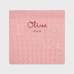 Merino baby blanket with rosette design and personalized embroidery.