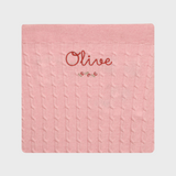 Merino baby blanket with rosette design and personalized embroidery.