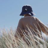 Child wearing Digger Personalised Bucket Hat in field.