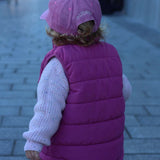Airplane personalised hat in pink worn by child, featuring custom embroidered name on back.