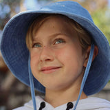 Customised bucket hat made of 100% washed cotton worn by a child, suitable for personalisation and embroidery.