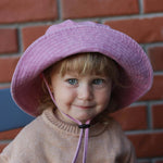 TMC Personalised Bucket Hat in pink worn by a young child, made of 100% washed cotton, suitable for ages 2-6, designed in Auckland.