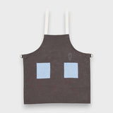 Kids blue on stone grey linen apron with embroidery and adjustable straps.